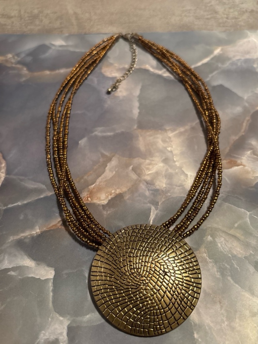 Multi-Strand Gold Beaded Necklace with Textured Round Medallion